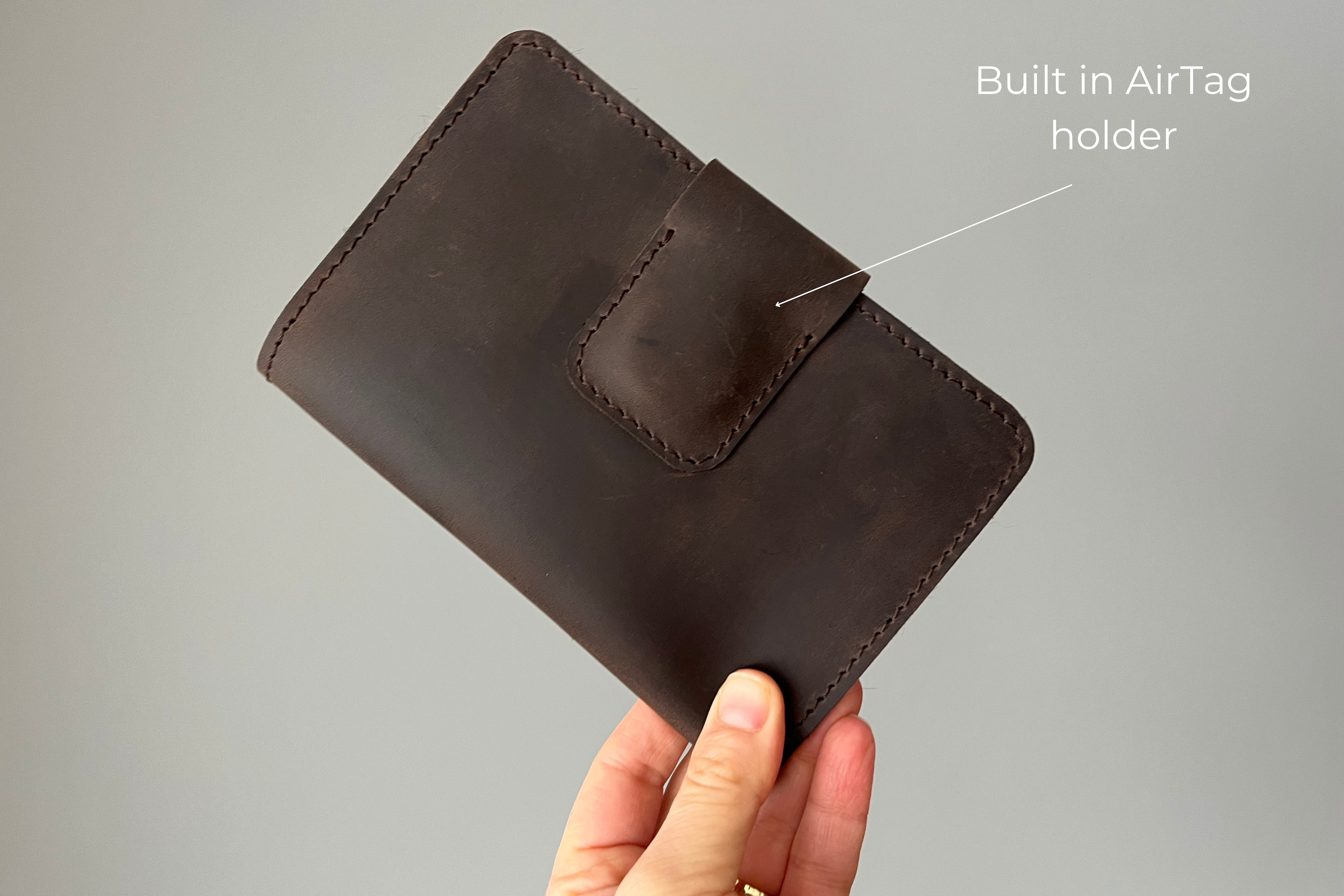 Leather passport wallet with integrated AirTag slot, crafted from premium cowhide leather