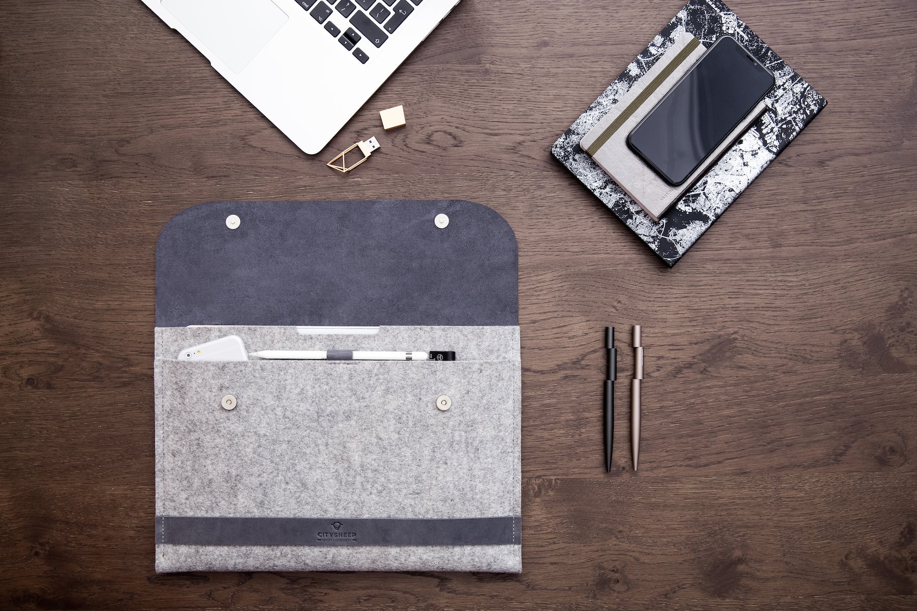 Protective MacBook Wool felt and leather case with magnetic closure. Room for MacBook, charger, accessories.