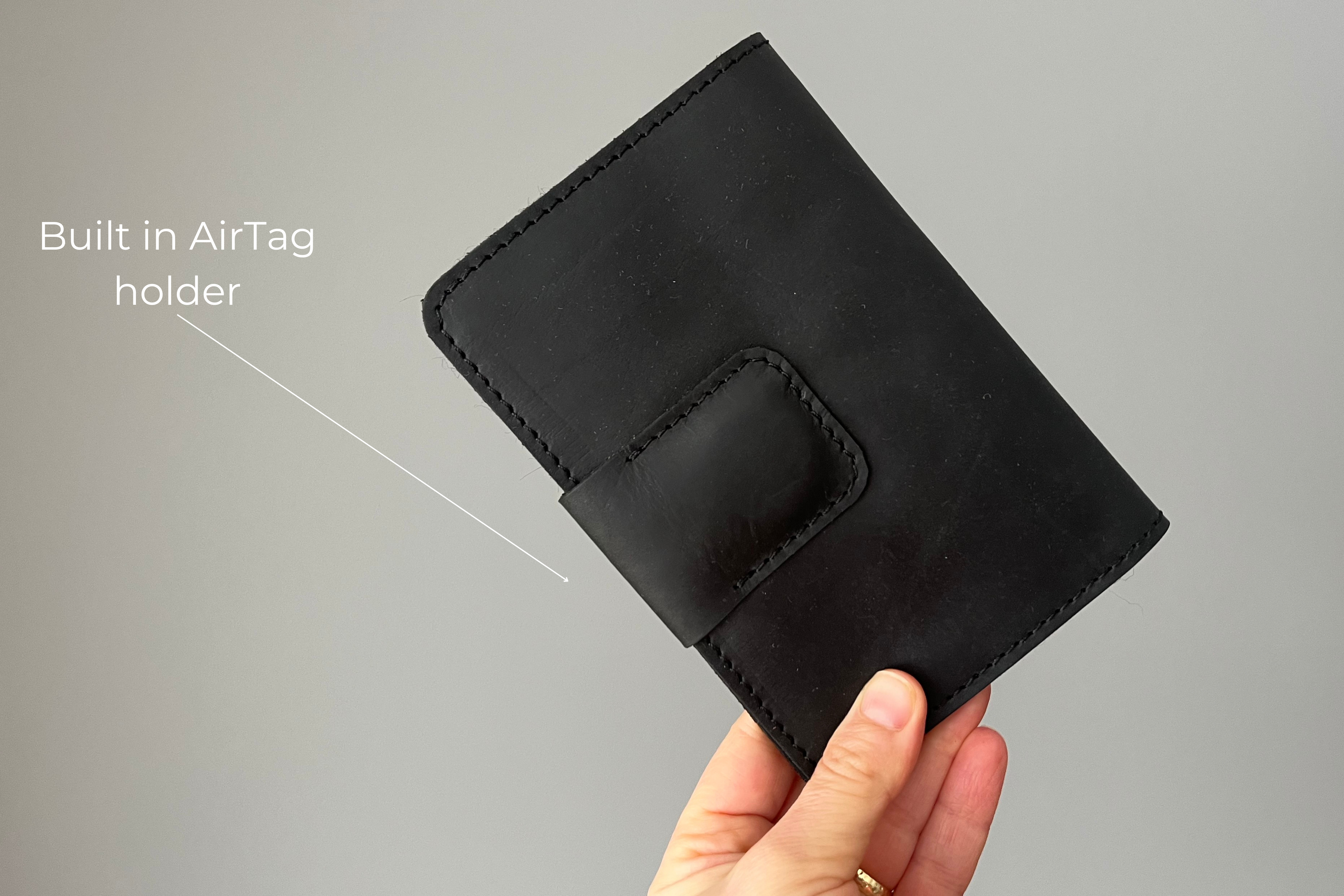 Black leather passport wallet with AirTag slot. Crafted from Premium Crazy Horse leather.