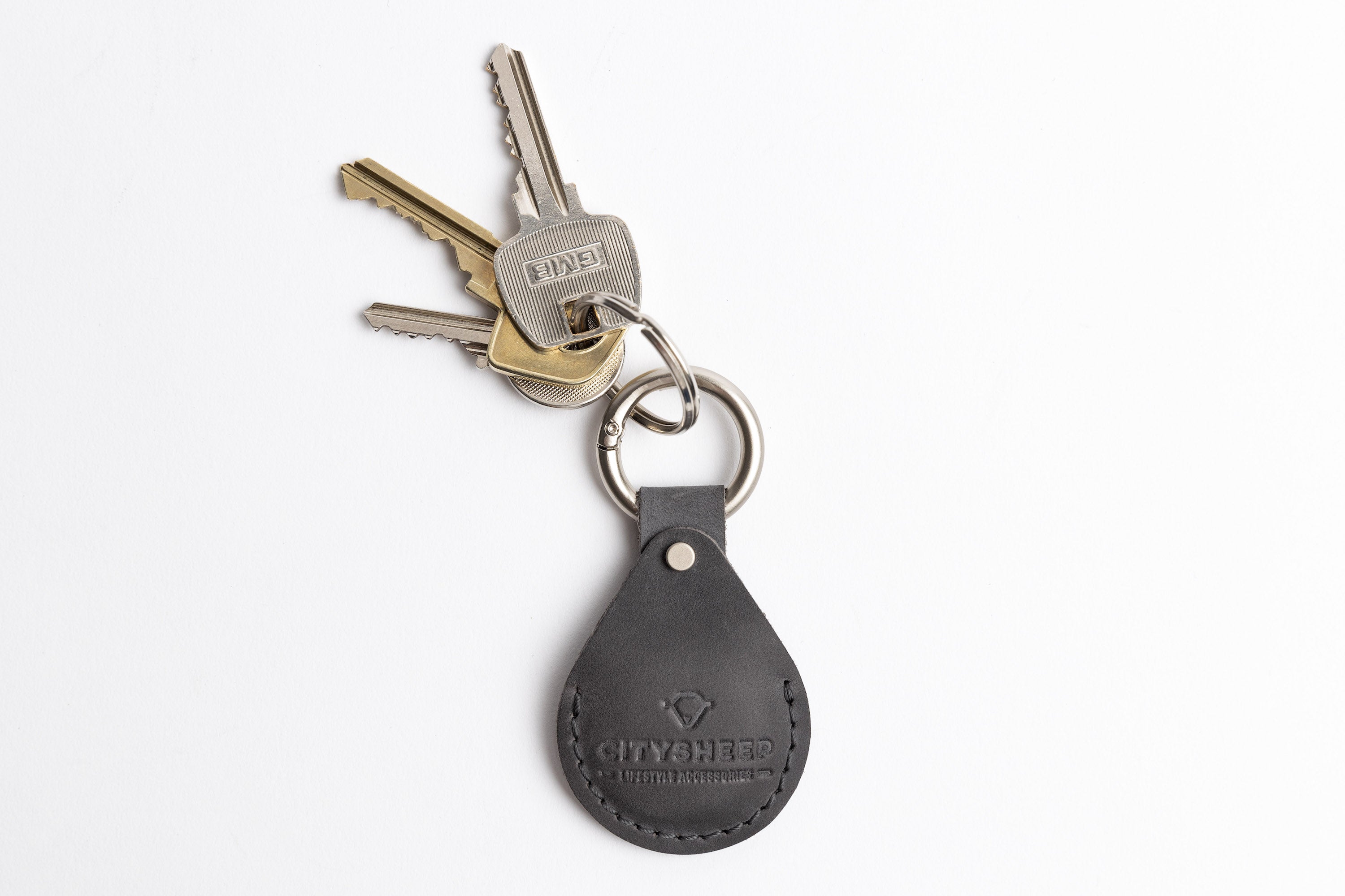 Leather AirTag holder in grey mat surface leather. 